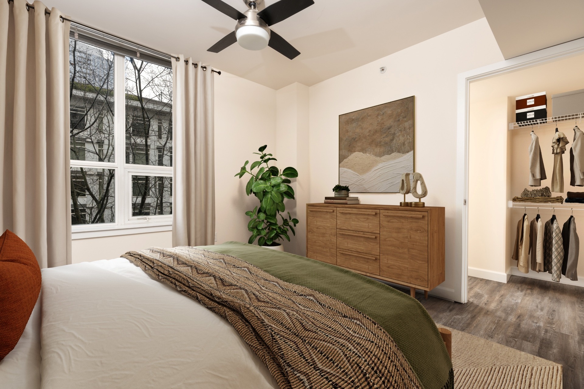 A bedroom with a bed, a ceiling fan, and a window with curtains.